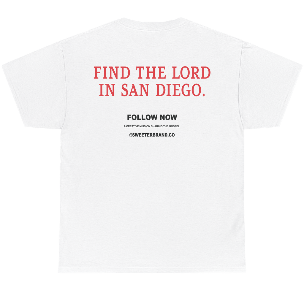 White short-sleeve t-shirt shown from the back, featuring red and black printed text on the center back that reads 'FIND THE LORD IN SAN DIEGO.' with smaller 'FOLLOW NOW' text below.
