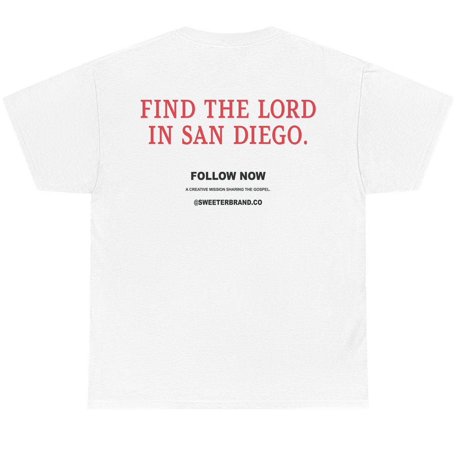 White short-sleeve t-shirt shown from the back, featuring red and black printed text on the center back that reads 'FIND THE LORD IN SAN DIEGO.' with smaller 'FOLLOW NOW' text below.