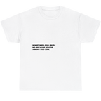 A white short-sleeve crewneck t-shirt with black printed text on the chest that reads 'SOMETIMES GOD SAYS NO BECAUSE YOU'RE AIMING TOO LOW.'.