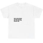 A white short-sleeve crewneck t-shirt with a black printed text quote on the chest, displayed against a solid white background.