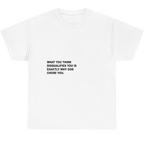 A white short-sleeve crewneck t-shirt with black printed text on the chest that reads, 'WHAT YOU THINK DISQUALIFIES YOU IS EXACTLY WHY GOD CHOSE YOU.'.