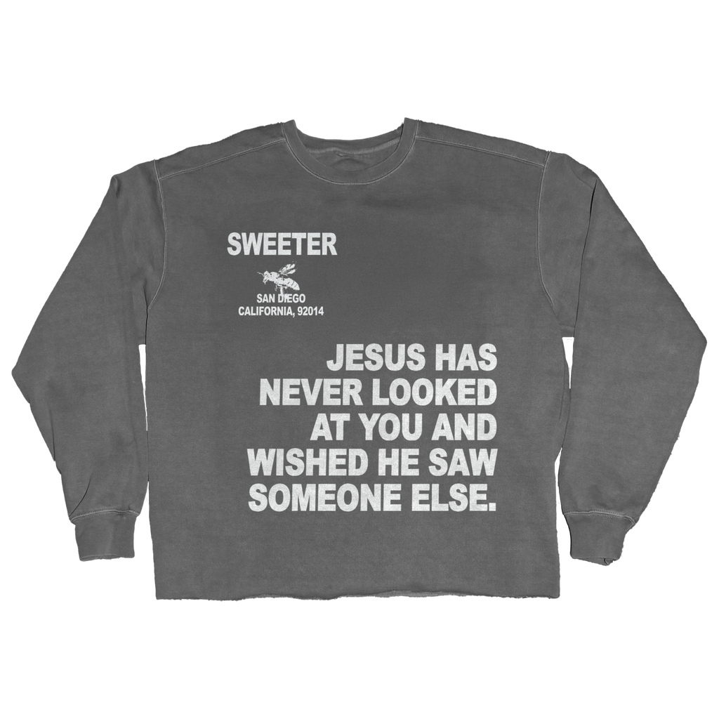 A dark gray crewneck sweatshirt with white printed text on the front reading 'SWEETER SAN DIEGO CALIFORNIA, 92014' and 'JESUS HAS NEVER LOOKED AT YOU AND WISHED HE SAW SOMEONE ELSE.'.