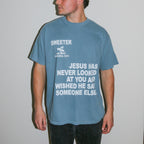 A man wearing a dusty blue graphic t-shirt with white text that reads 'SWEETER SAN DIEGO CALIFORNIA 2014' and 'JESUS HAS NEVER LOOKED AT YOU AND WISHED HE SAID SOMEONE ELSE'.