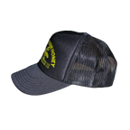 A dark gray and black trucker hat with a yellow embroidered logo on the front panel, featuring a curved brim and mesh back.