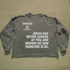 A dark gray long-sleeve t-shirt with white printed text on the front, laid flat on a concrete surface. The text reads 'SWEETER SAN ANGLO CALIFORNIA, 92014' and 'JESUS HAS NEVER LOOKED AT YOU AND WISHED HE SAW SOMEONE ELSE.